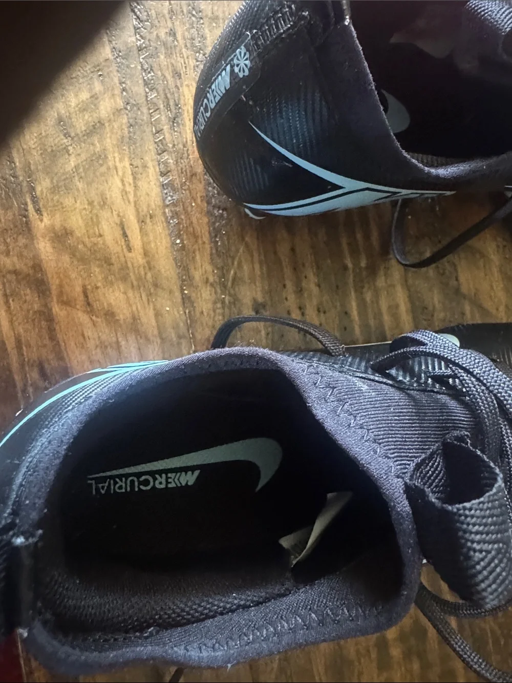 Nike Black Cleats with Light Blue Swoosh